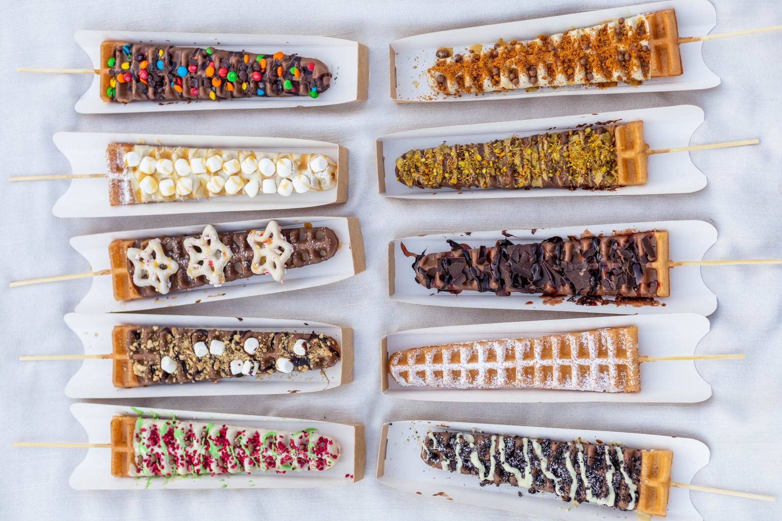 All ten waffle wands laid out in paper trays, seen from above